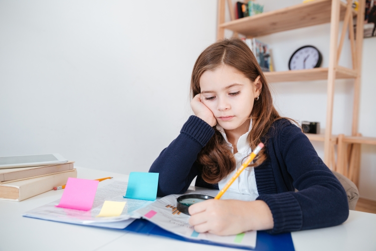graphicstock-serious-little-girl-sitting-and-writing-at-the-table-in-classroom_SdMJHaiL3e.jpg